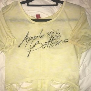 Yellow apple bottom shirt, ripped up back.